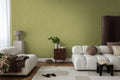 The Olive Loom | Moss Green Luxe wallpaper hung behind cream sofas and a dark side table in a living room