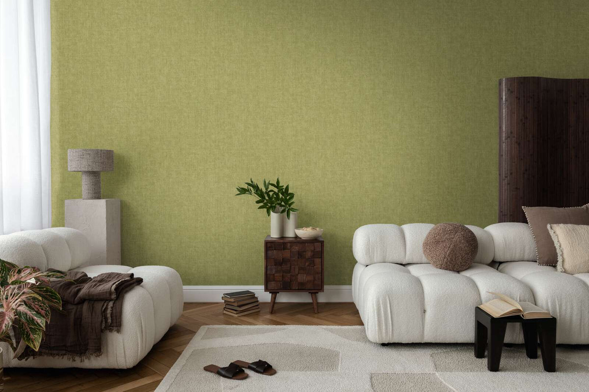 The Olive Loom | Moss Green Luxe wallpaper hung behind cream sofas and a dark side table in a living room