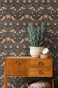 The Agapanthus Conservatory | Deep Black & Smoked Grey Luxe wallpaper shown hung on a styled interior wall