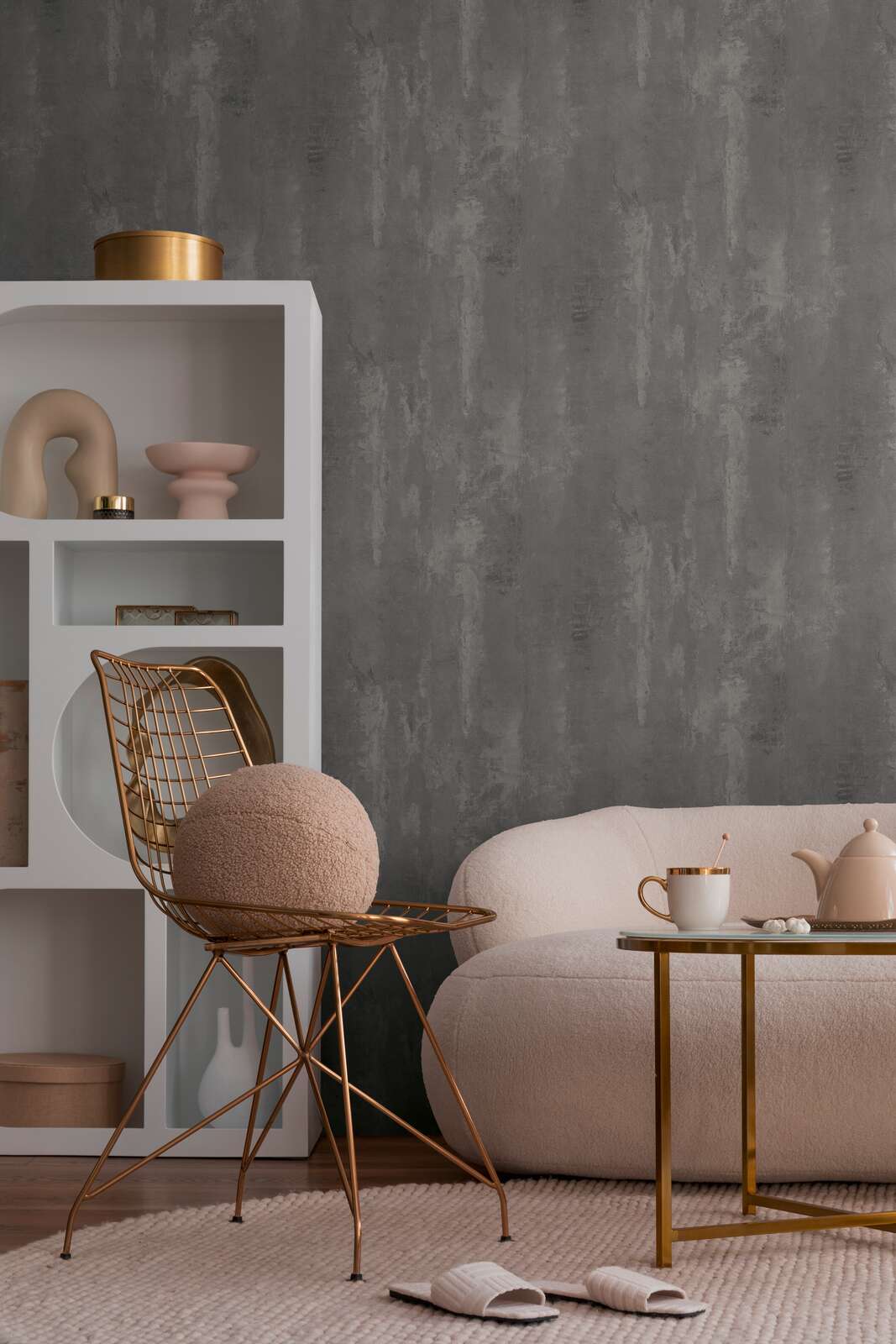 The Basalt Foundry | Charcoal Slate Luxe wallpaper hung behind a blush boucle pouf and white open shelving in a living corner