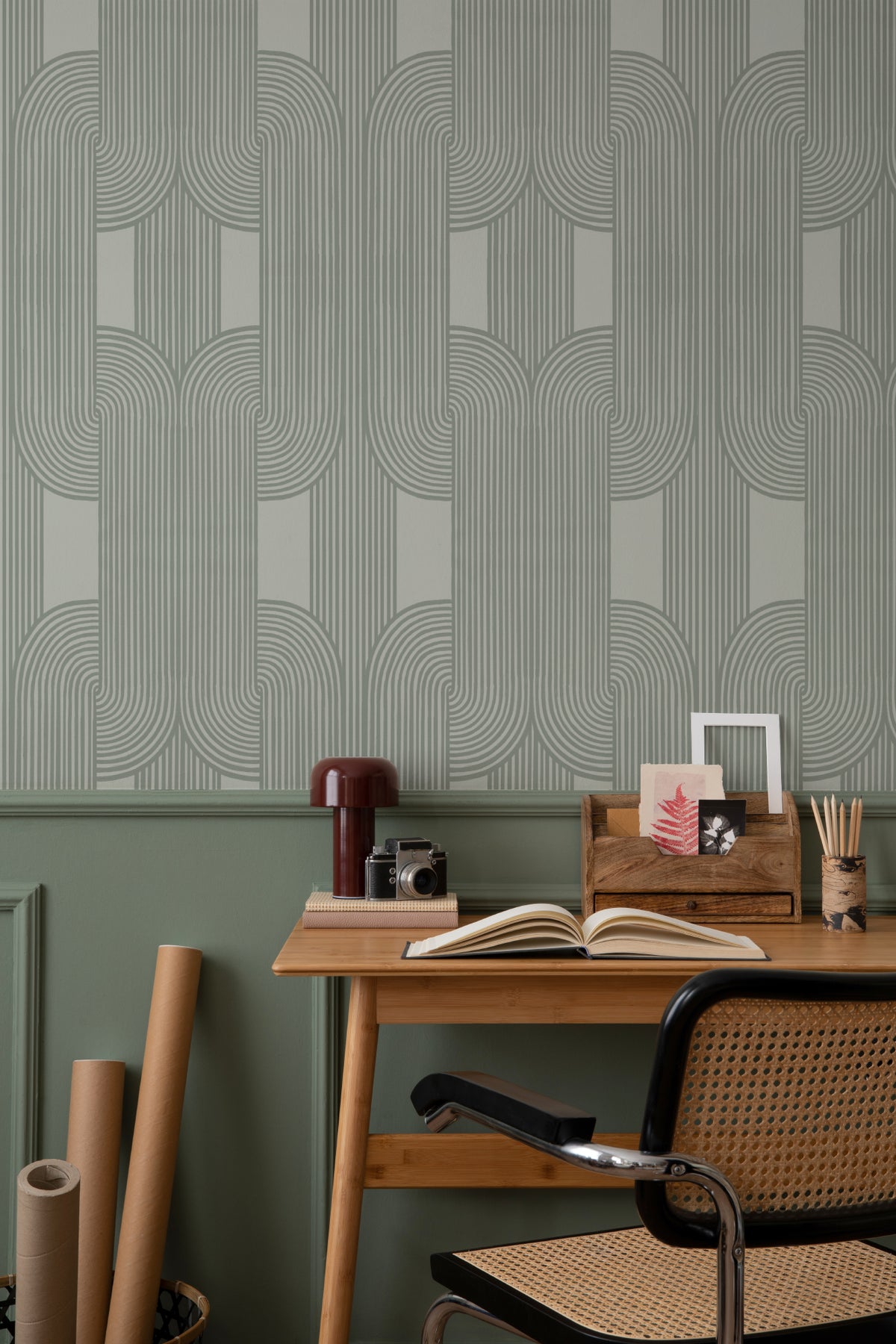 The Arcade Curve wallpaper in soft sage in a study corner with a desk