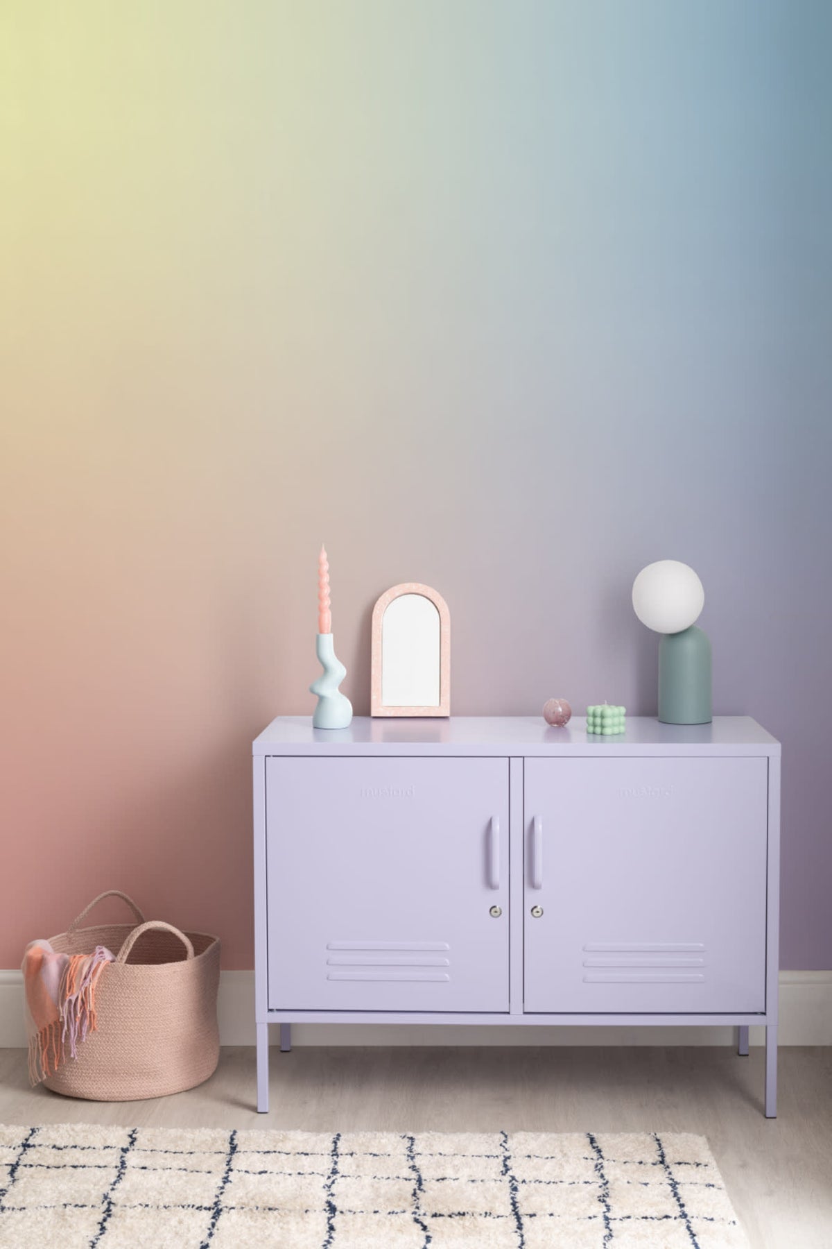 The Aurora Wash mural in sorbet rainbow behind a styled console