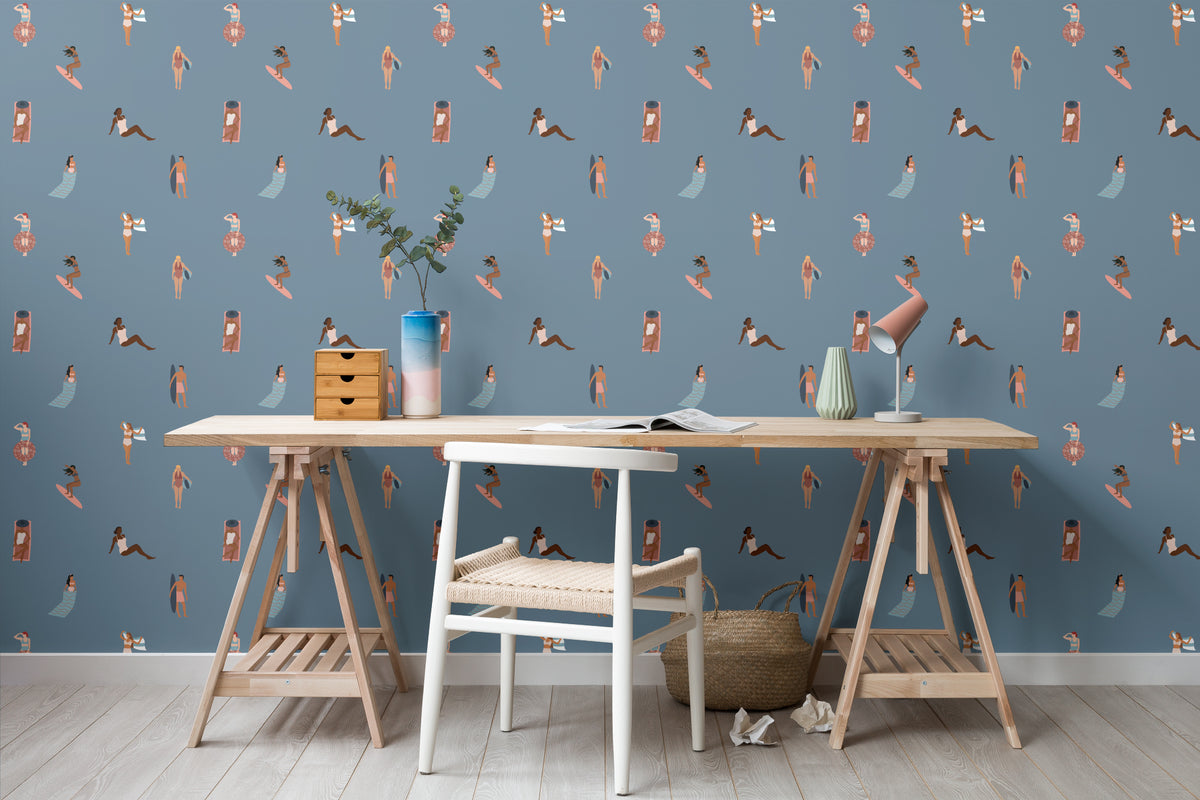 The Bathing Promenade wallpaper in dusk blue behind a desk in a home office