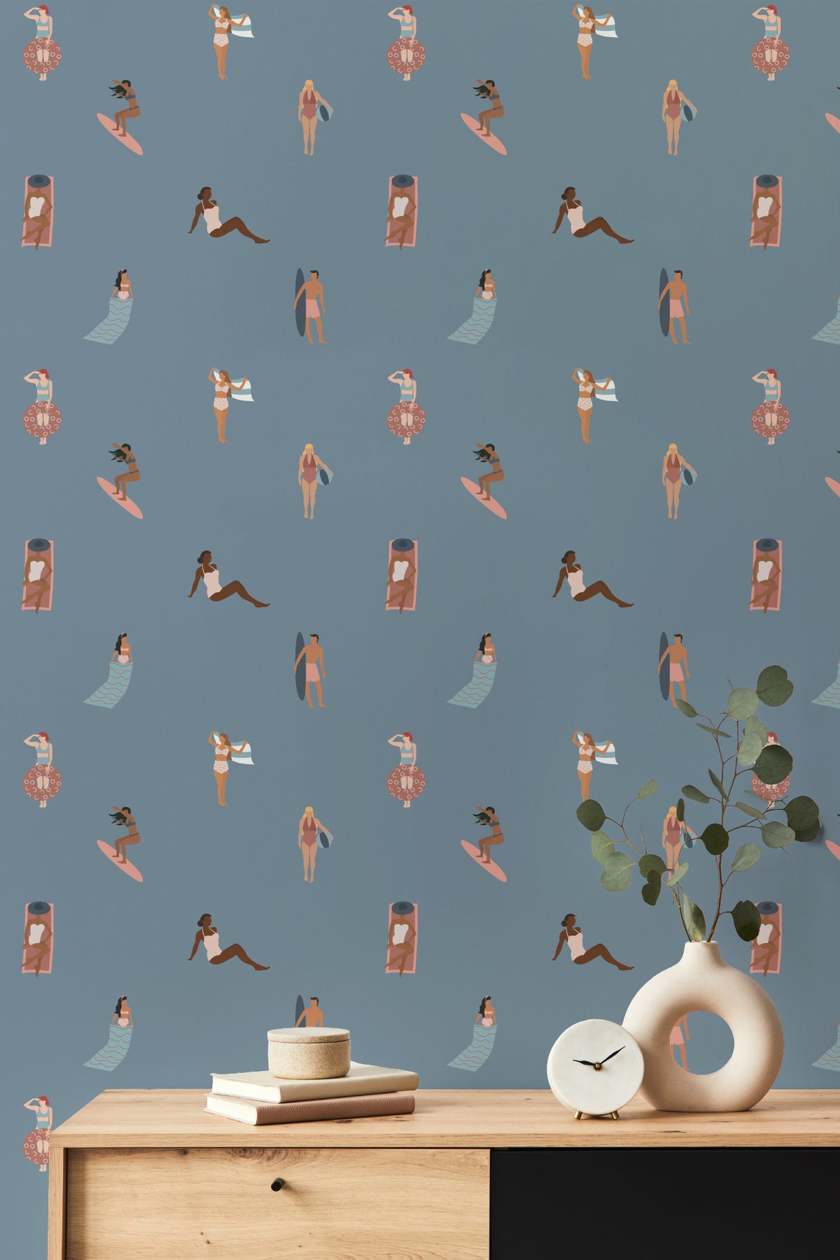 The Bathing Promenade wallpaper in dusk blue behind a styled console