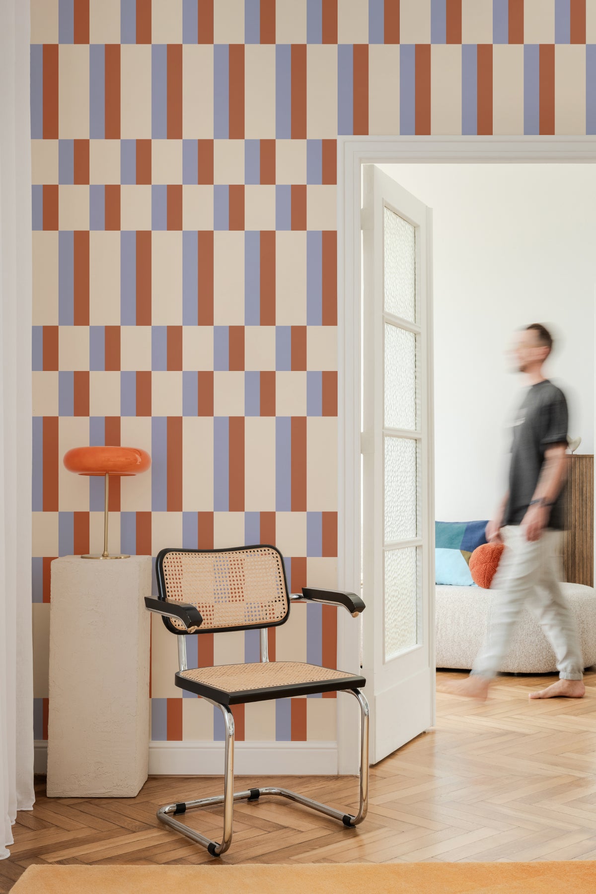 The Bauhaus Block wallpaper in periwinkle and rust in a hallway
