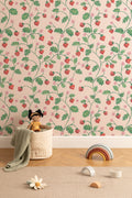 The Berry Arbour wallpaper in blush beige behind a styled console
