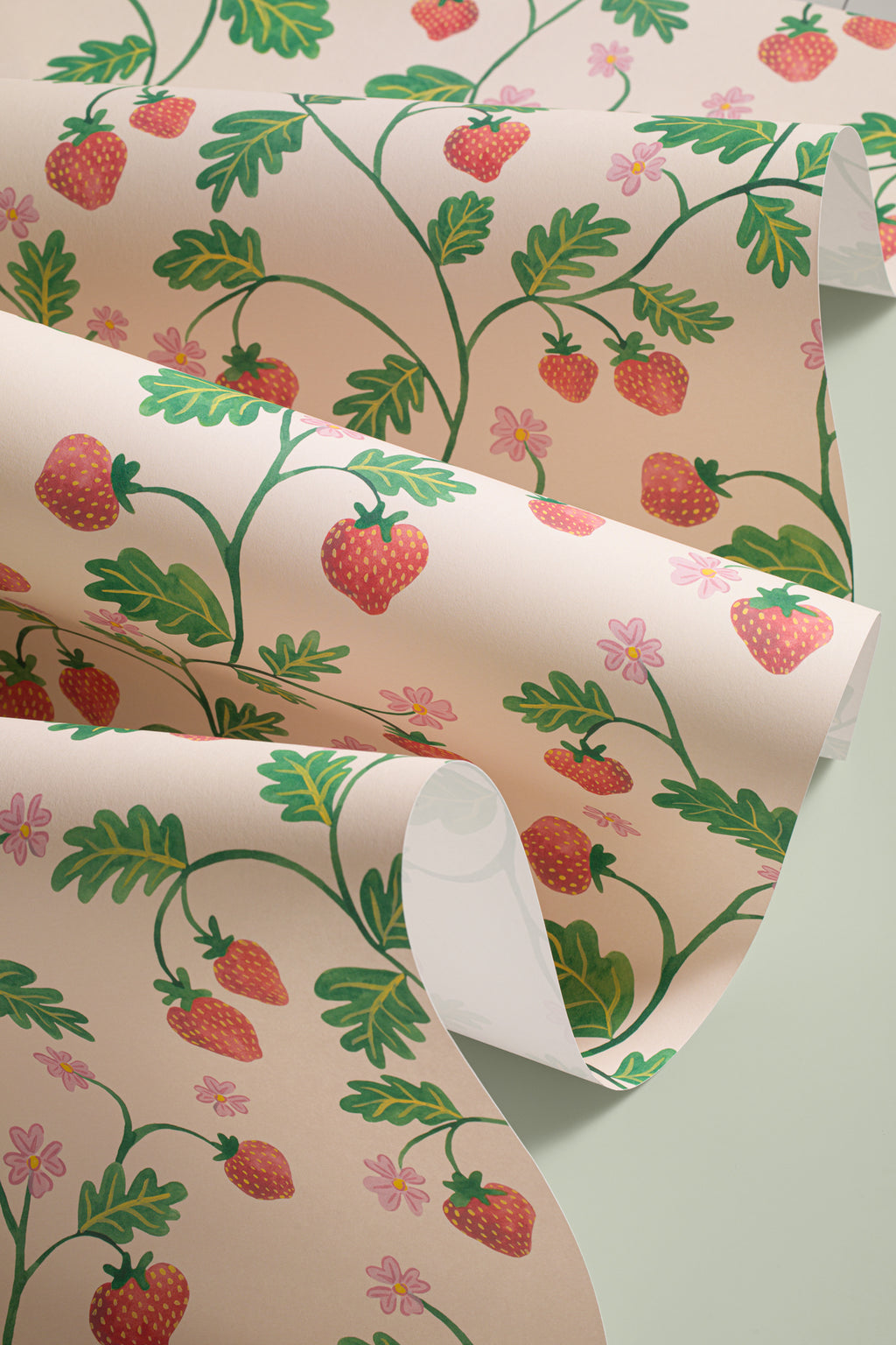 Angled detail of The Berry Arbour wallpaper in blush beige