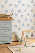 The Bluebird Flight wallpaper in cornflower blue behind a styled console