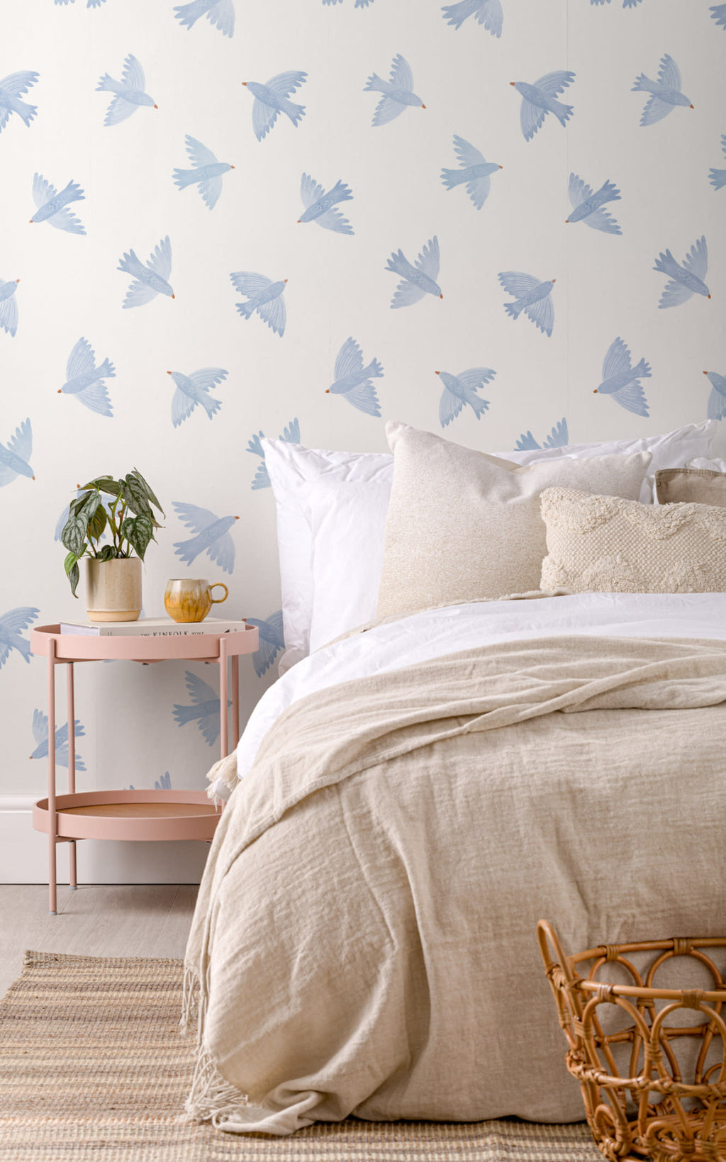 The Bluebird Flight wallpaper in cornflower blue behind the bed in a bedroom