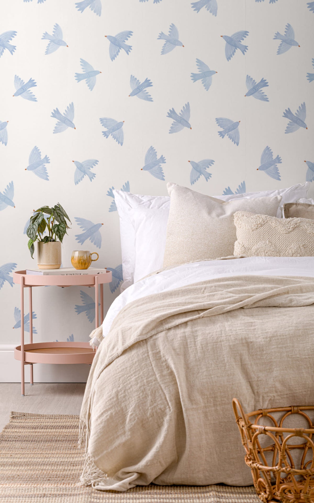 The Bluebird Flight wallpaper in cornflower blue behind the bed in a bedroom