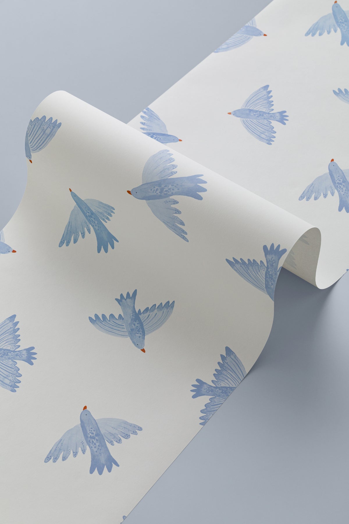 Angled detail of The Bluebird Flight wallpaper in cornflower blue