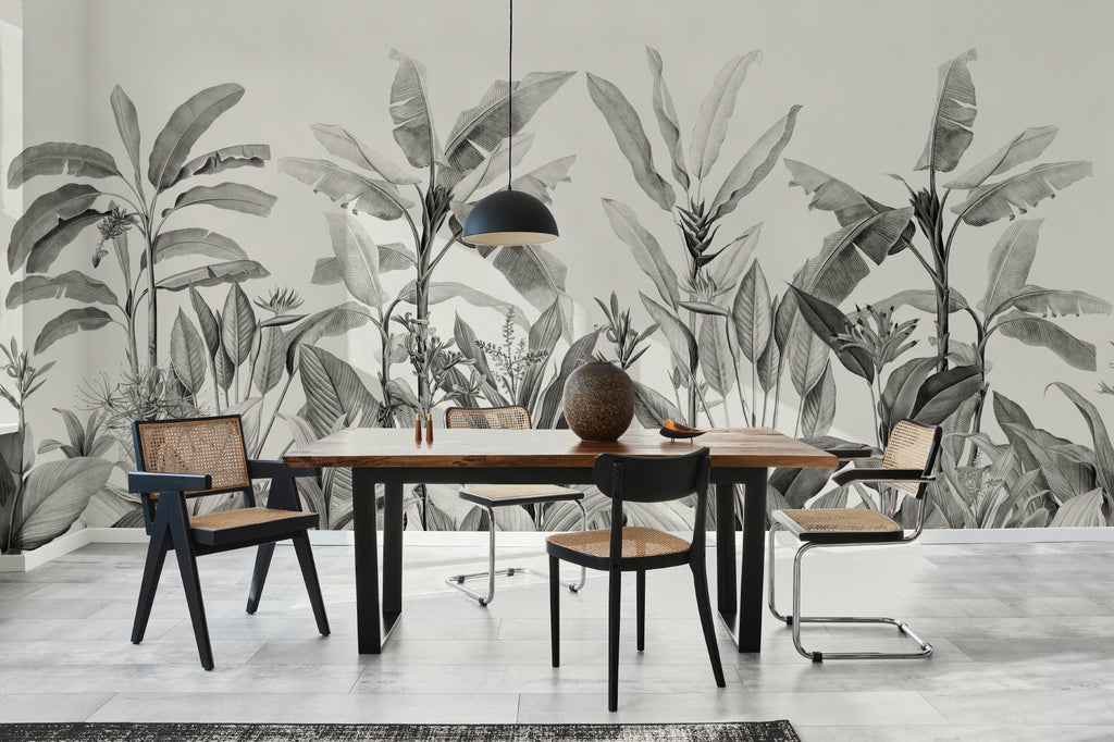 The Botanic Frieze mural in charcoal and white behind a dining table