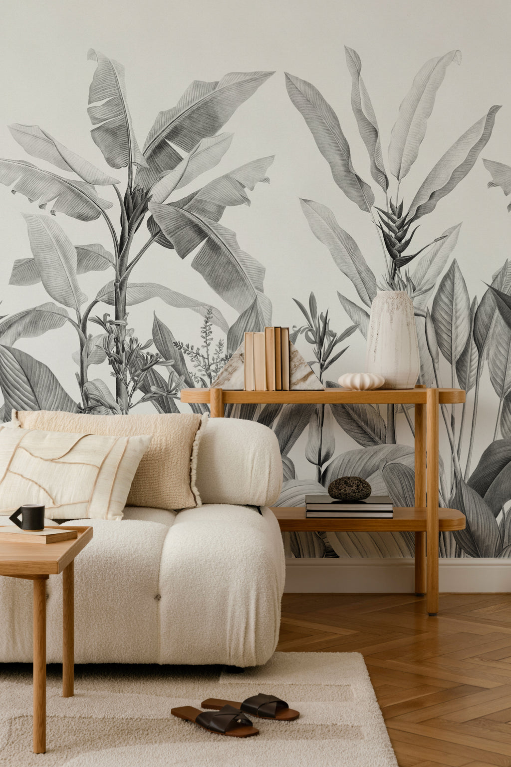 The Botanic Frieze mural in charcoal and white behind seating in a living room
