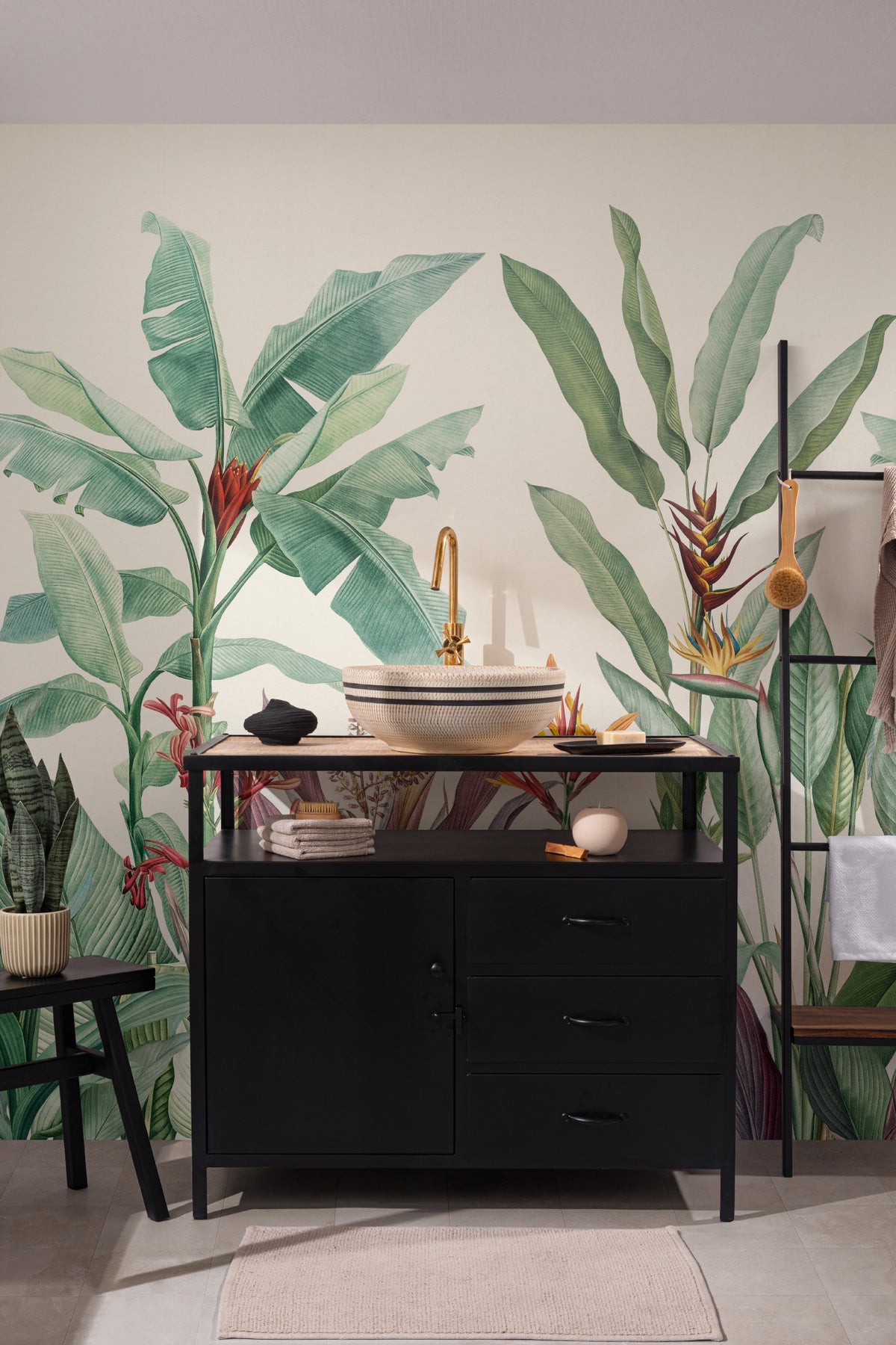 The Botanic Frieze mural in tropical green as a backdrop to styled furniture