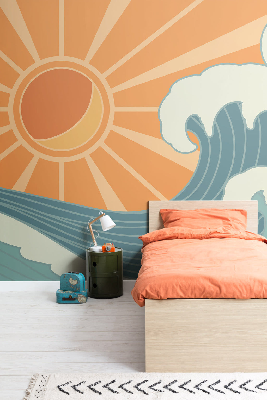 The Breakwater Sun mural in tangerine and teal on a nursery wall