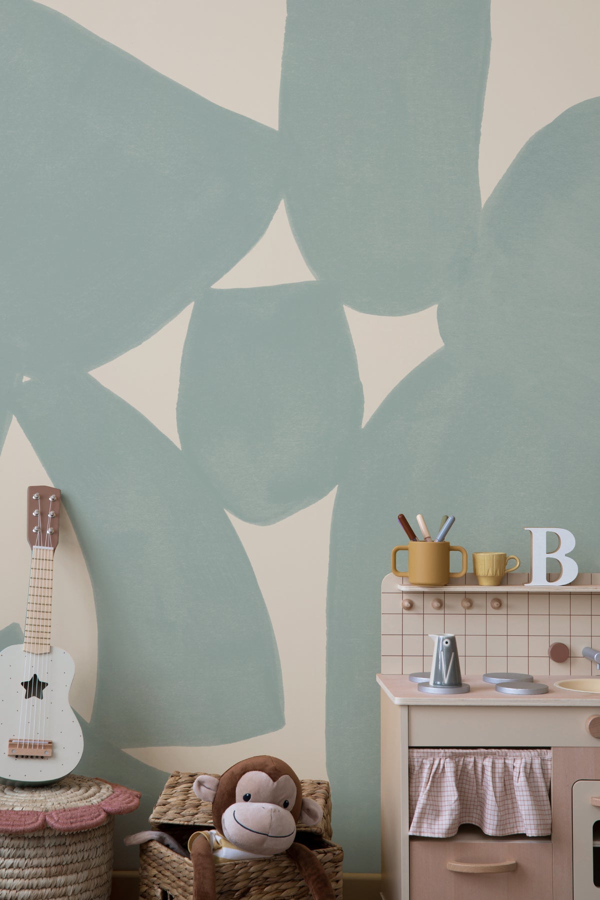 The Brushed Fragments mural in seafoam blue behind a styled console