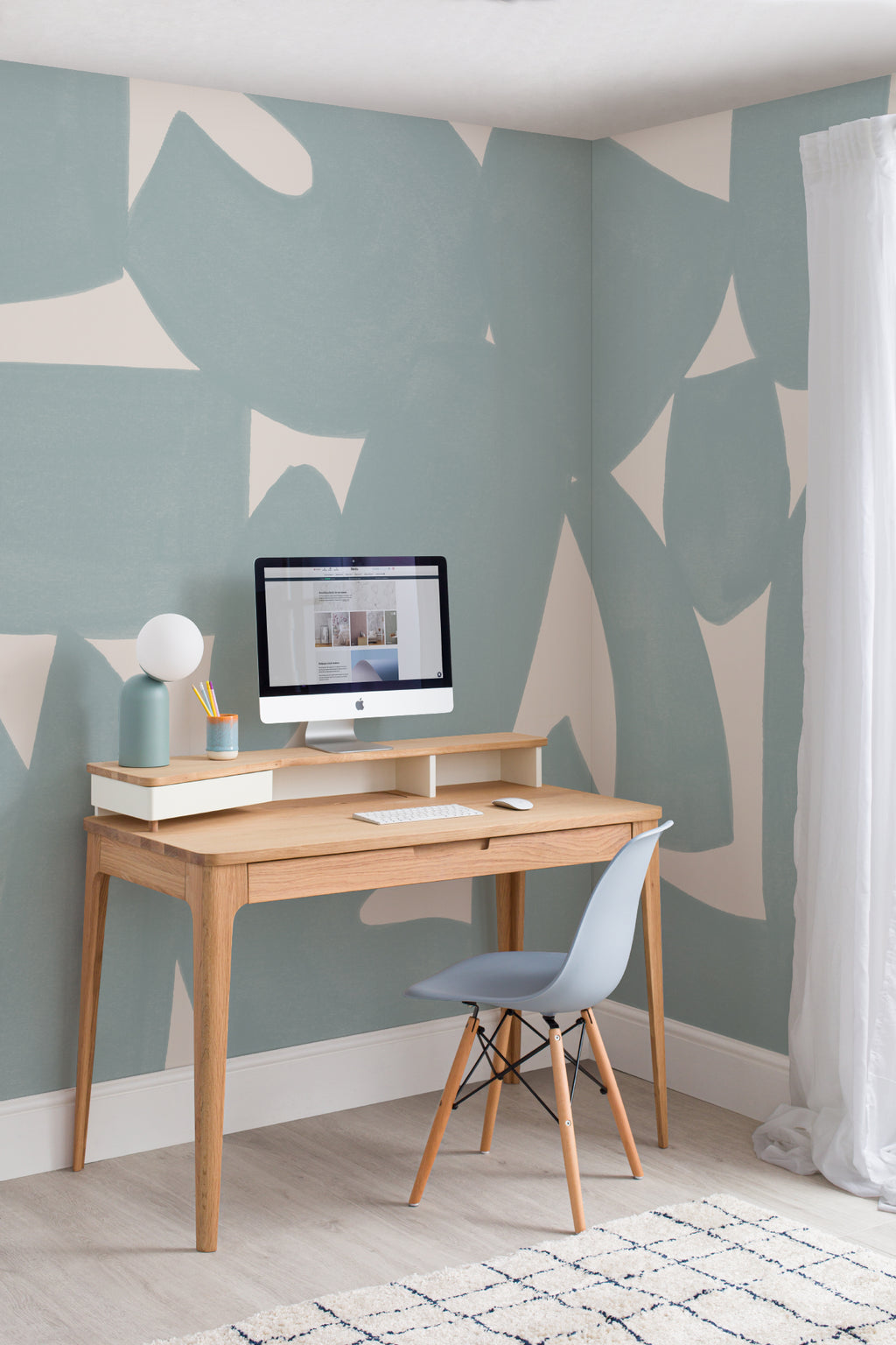 The Brushed Fragments mural in seafoam blue behind a desk in a home office