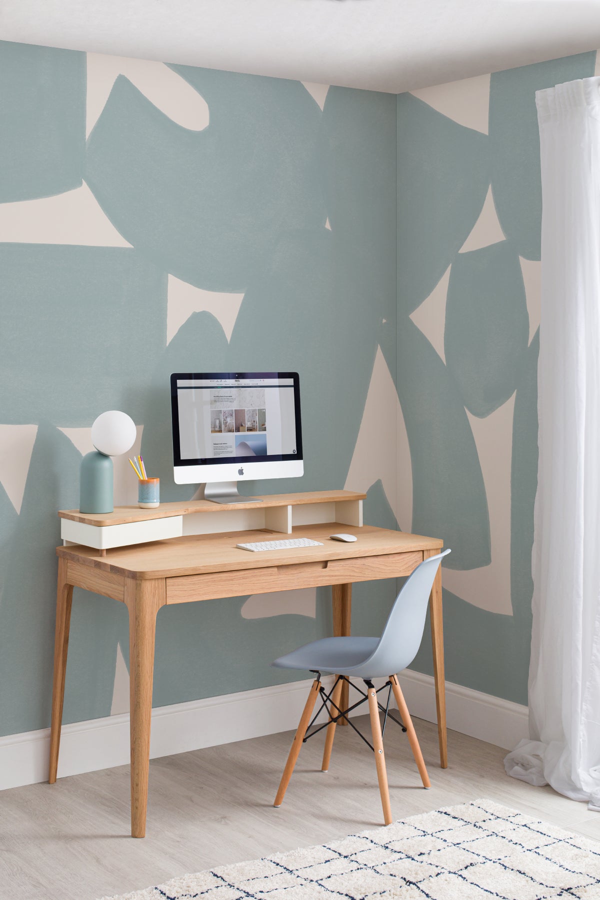 The Brushed Fragments mural in seafoam blue behind a desk in a home office