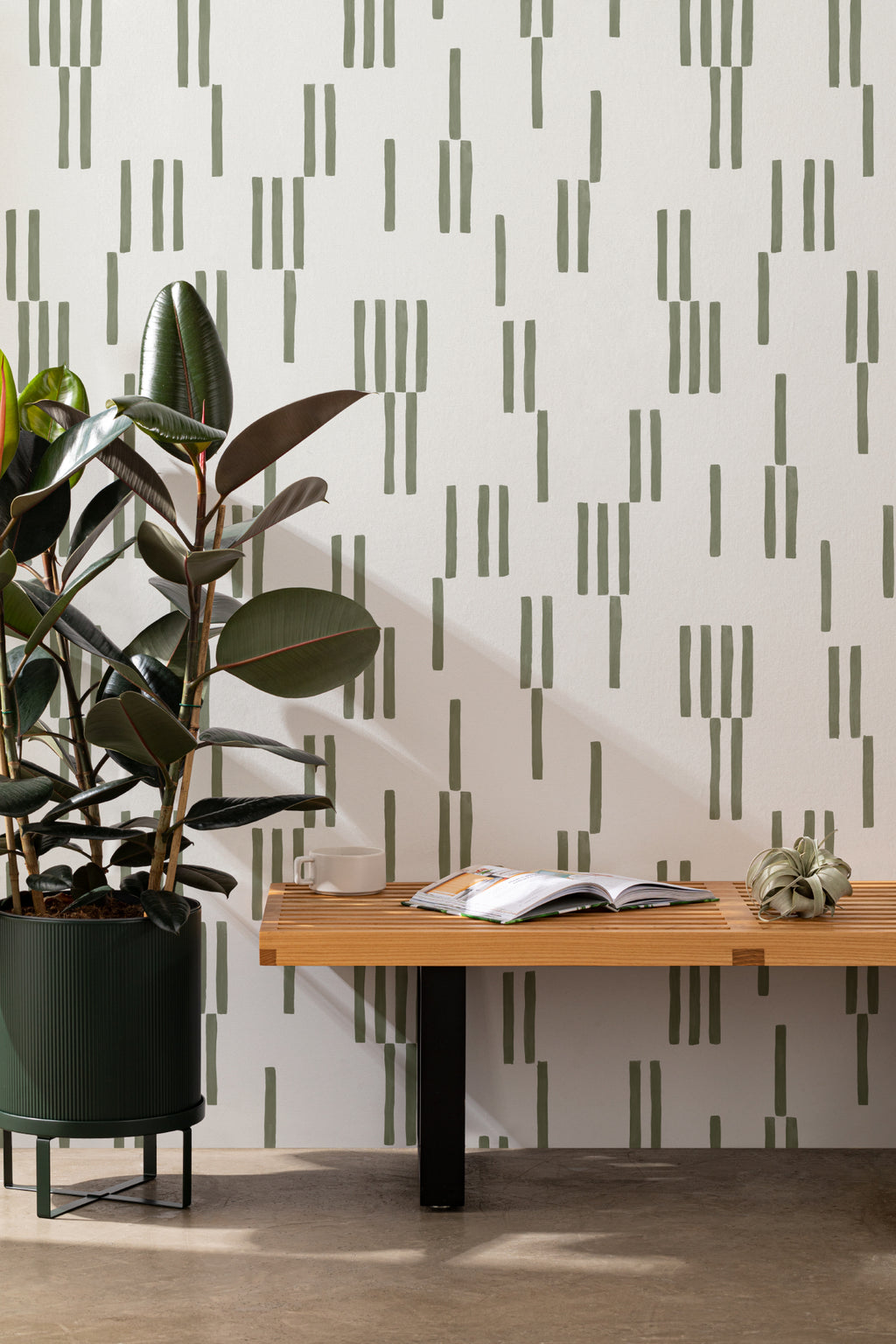 The Brushmark Column wallpaper in mossy green behind a styled console