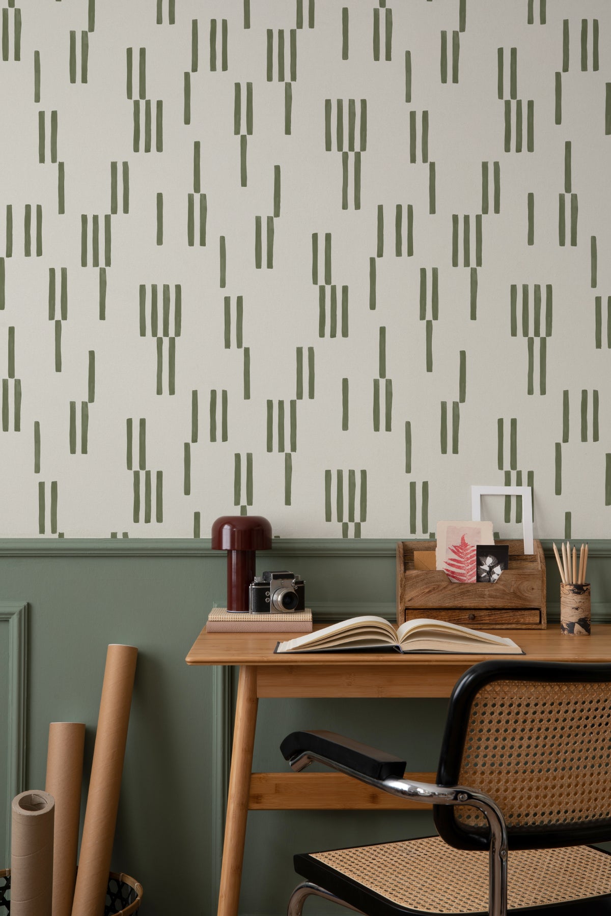 The Brushmark Column wallpaper in mossy green behind a desk in a home office