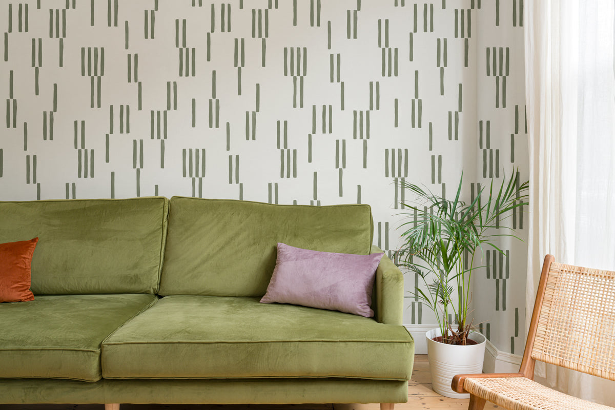 The Brushmark Column wallpaper in mossy green in a living room