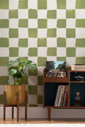 The Brushstroke Chequer wallpaper in olive moss behind a desk in a home office
