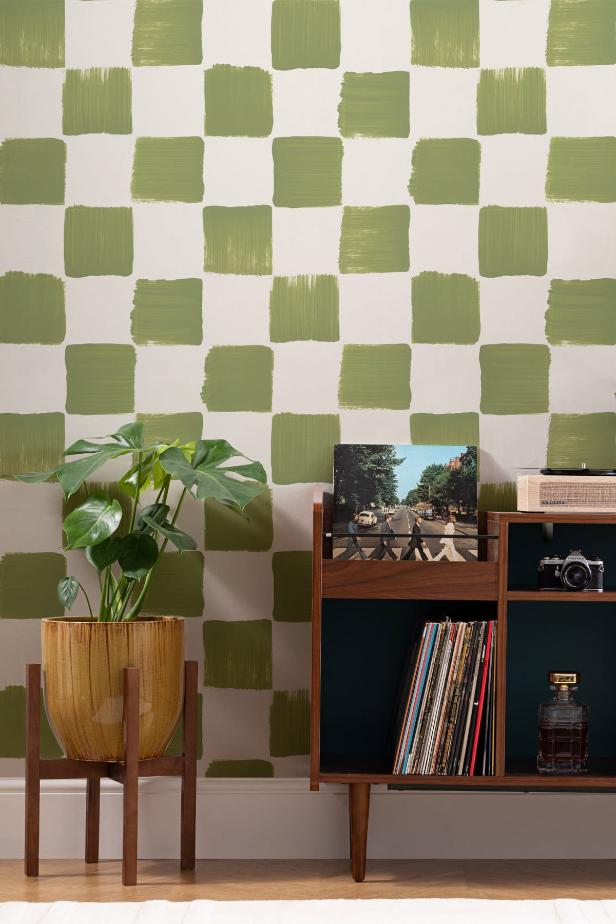 The Brushstroke Chequer wallpaper in olive moss behind a desk in a home office
