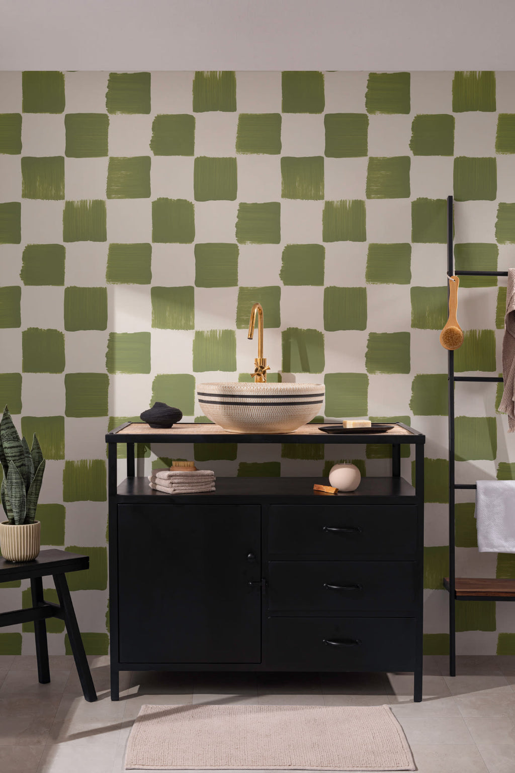 The Brushstroke Chequer wallpaper in olive moss behind a styled console