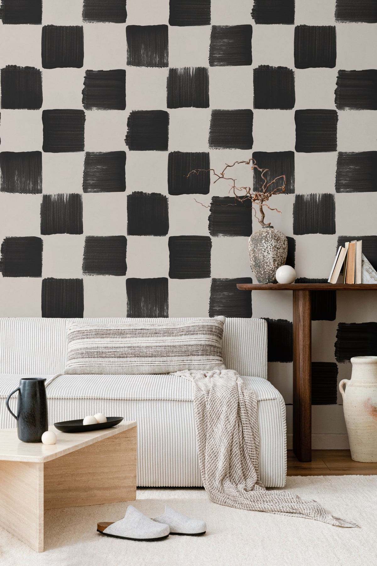 The Brushstroke Chequer wallpaper in onyx and beige behind the bed in a bedroom