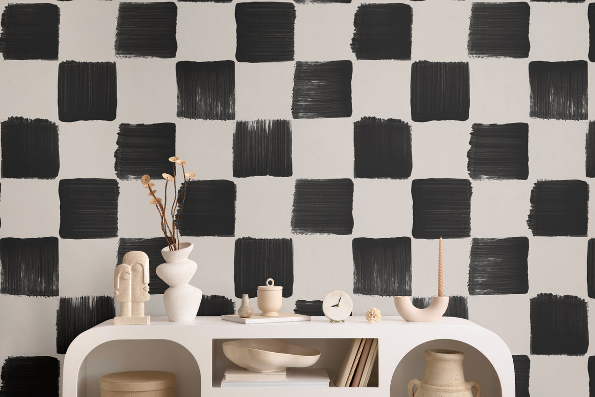 The Brushstroke Chequer wallpaper in onyx and beige behind a styled console