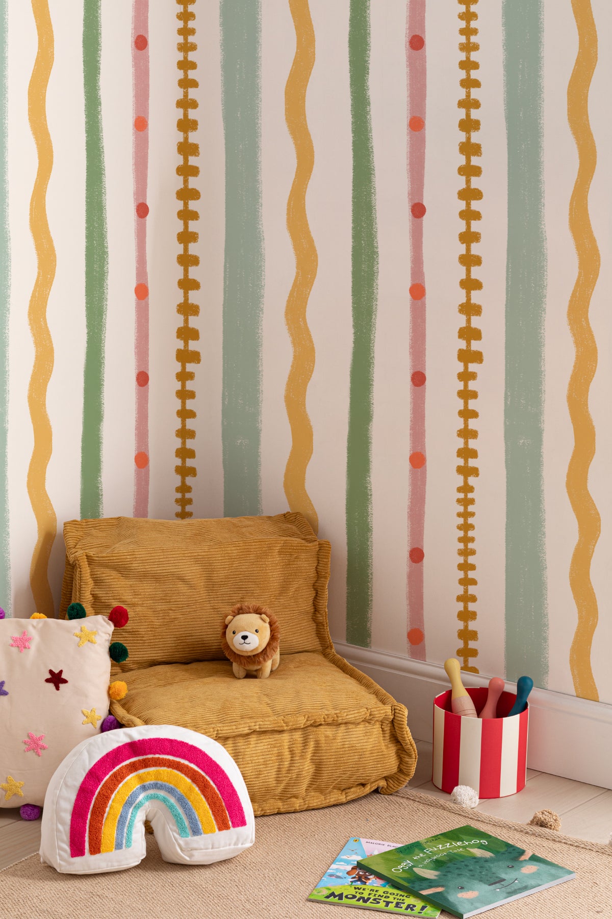 The Carousel Stripe mural in blush and pistachio in a children's room setting