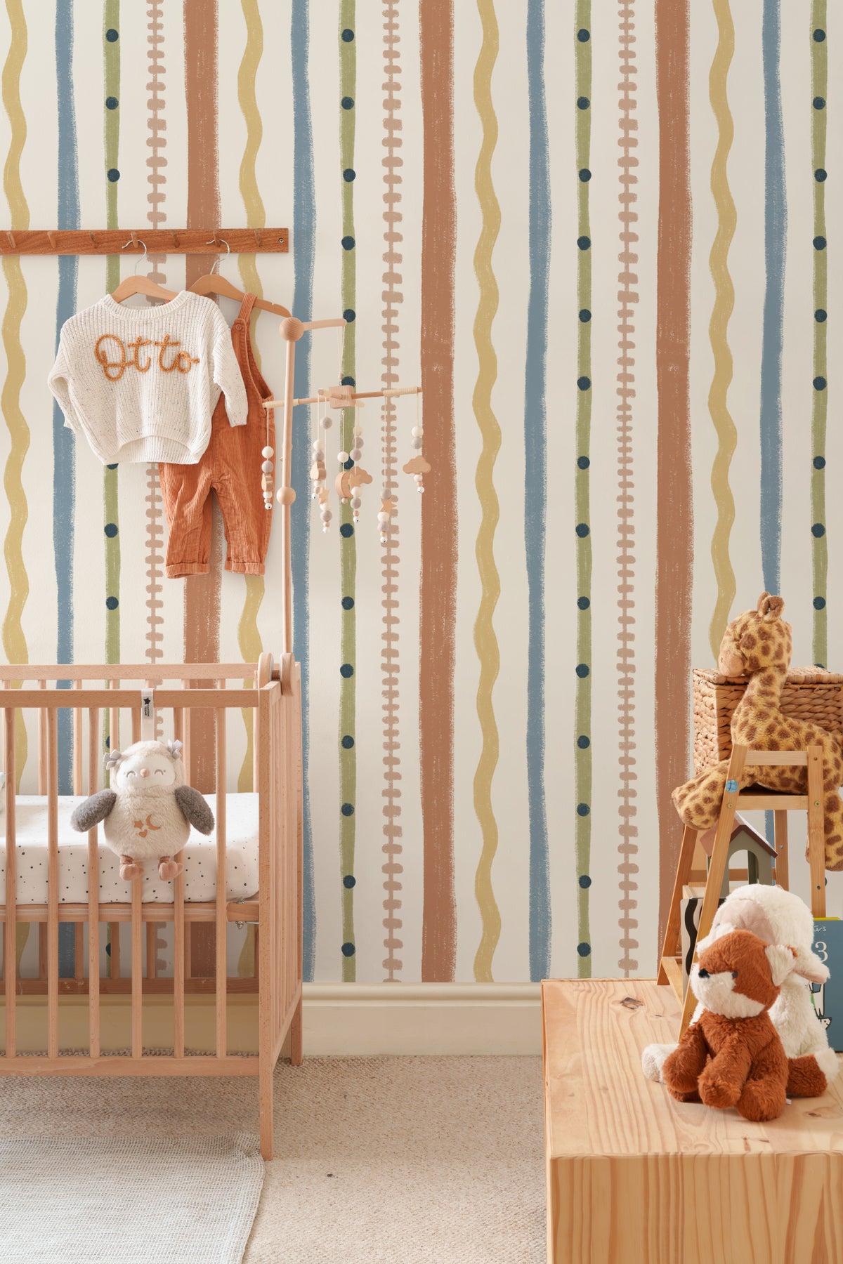 The Carousel Stripe mural in mustard and sky blue on a nursery wall