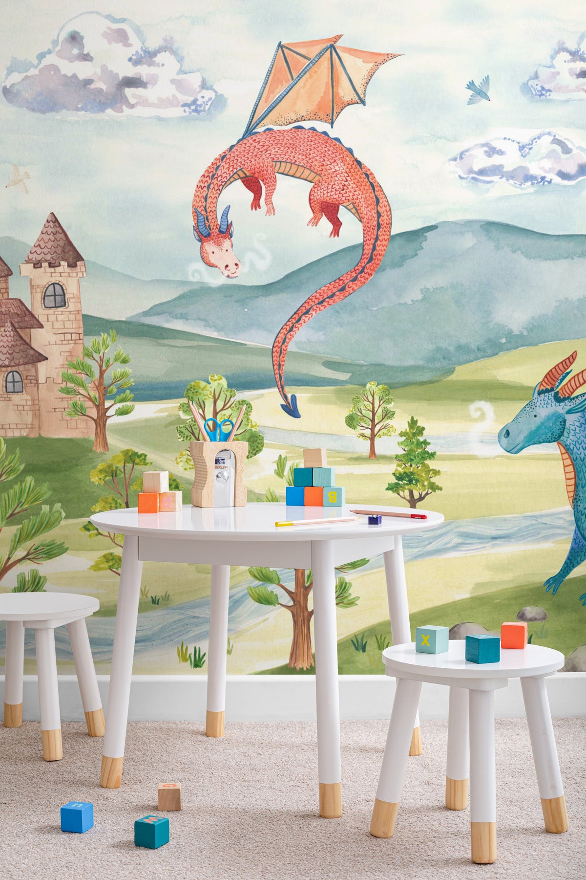 The Castle Storybook mural in dawn blue and meadow green on a nursery wall
