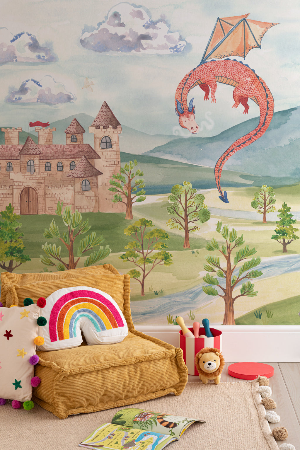 The Castle Storybook mural in dawn blue and meadow green behind a kids' play corner