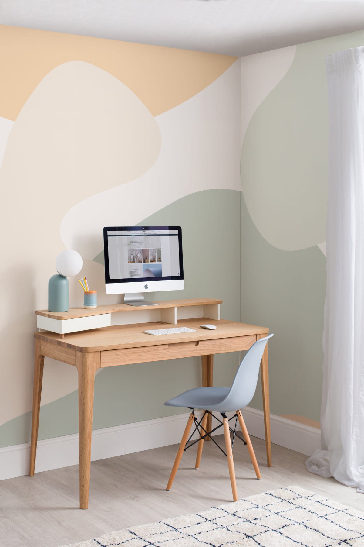 The Cloud Hills mural in sage and apricot behind a desk in a home office