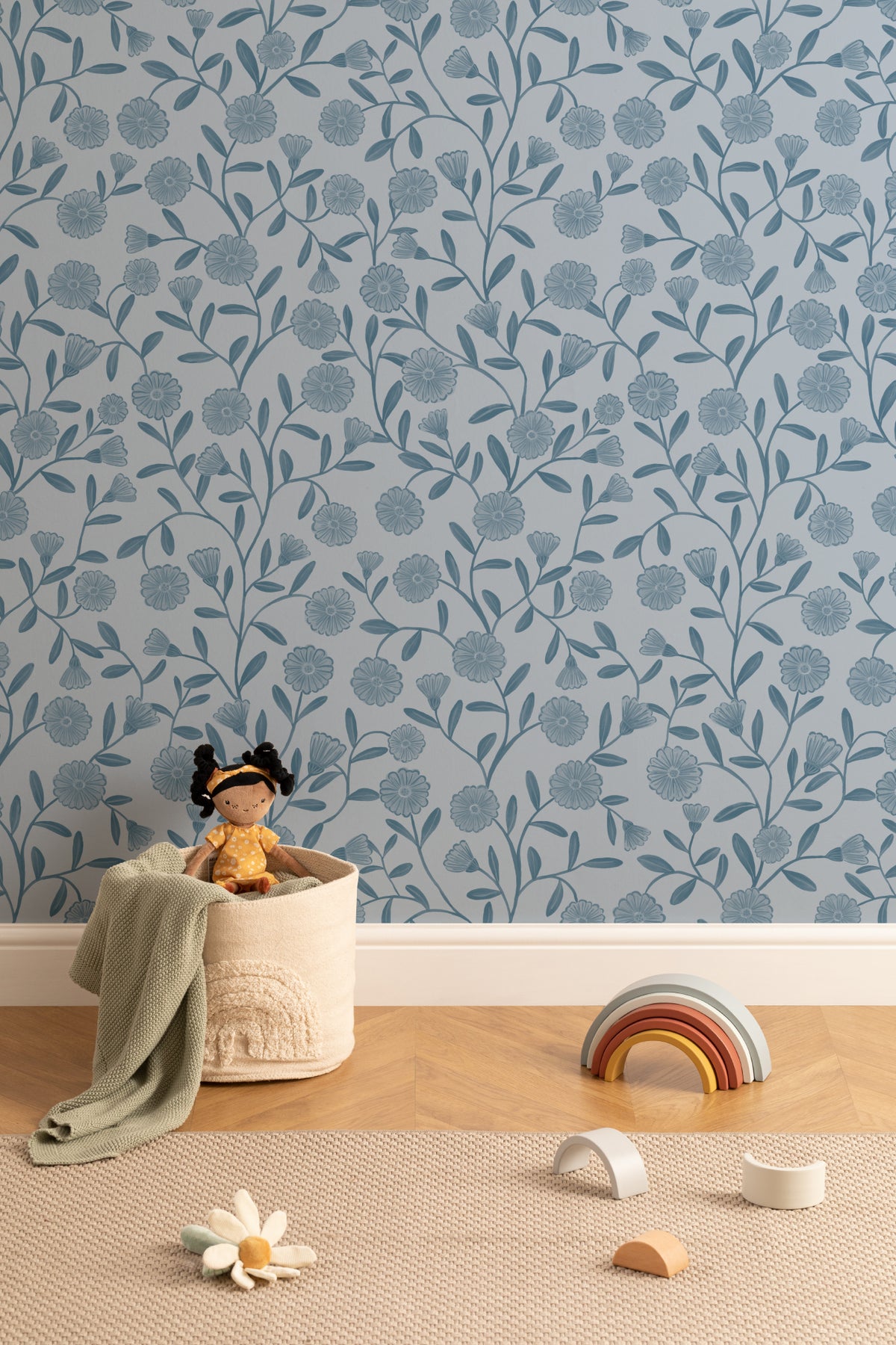 The Cottage Daisy wallpaper in denim blue behind a styled console