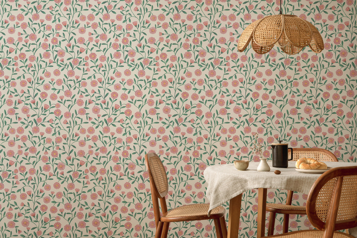 The Cottage Daisy wallpaper in rose pink behind a dining table