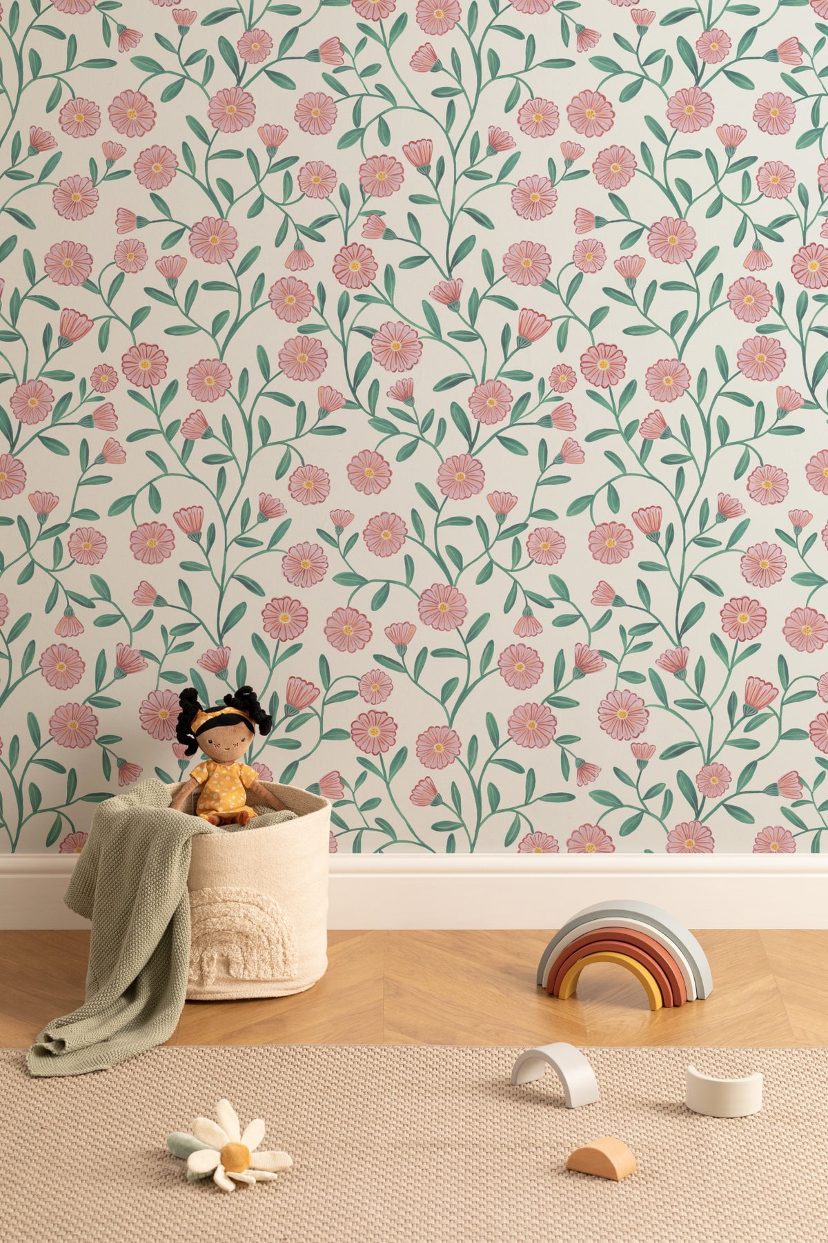 The Cottage Daisy wallpaper in rose pink on a nursery wall