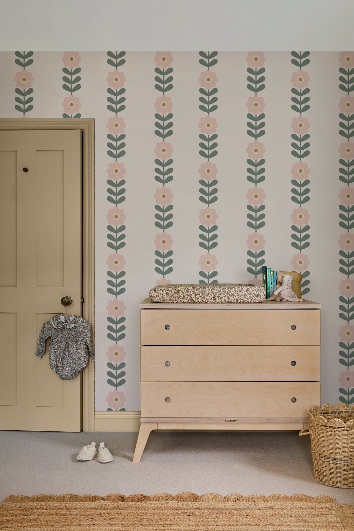 The Daisy Colonnade wallpaper in blush and oat behind a styled console