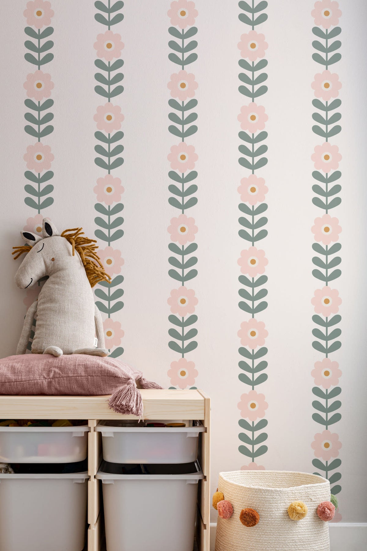 The Daisy Colonnade wallpaper in blush and oat on a nursery wall