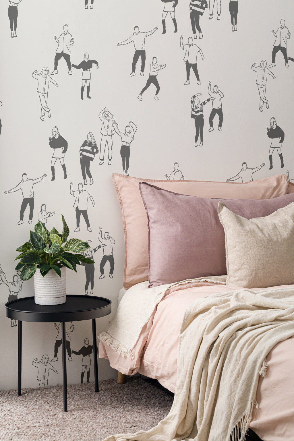 The Dancehall Sketch wallpaper in ink black and cream behind the bed in a bedroom