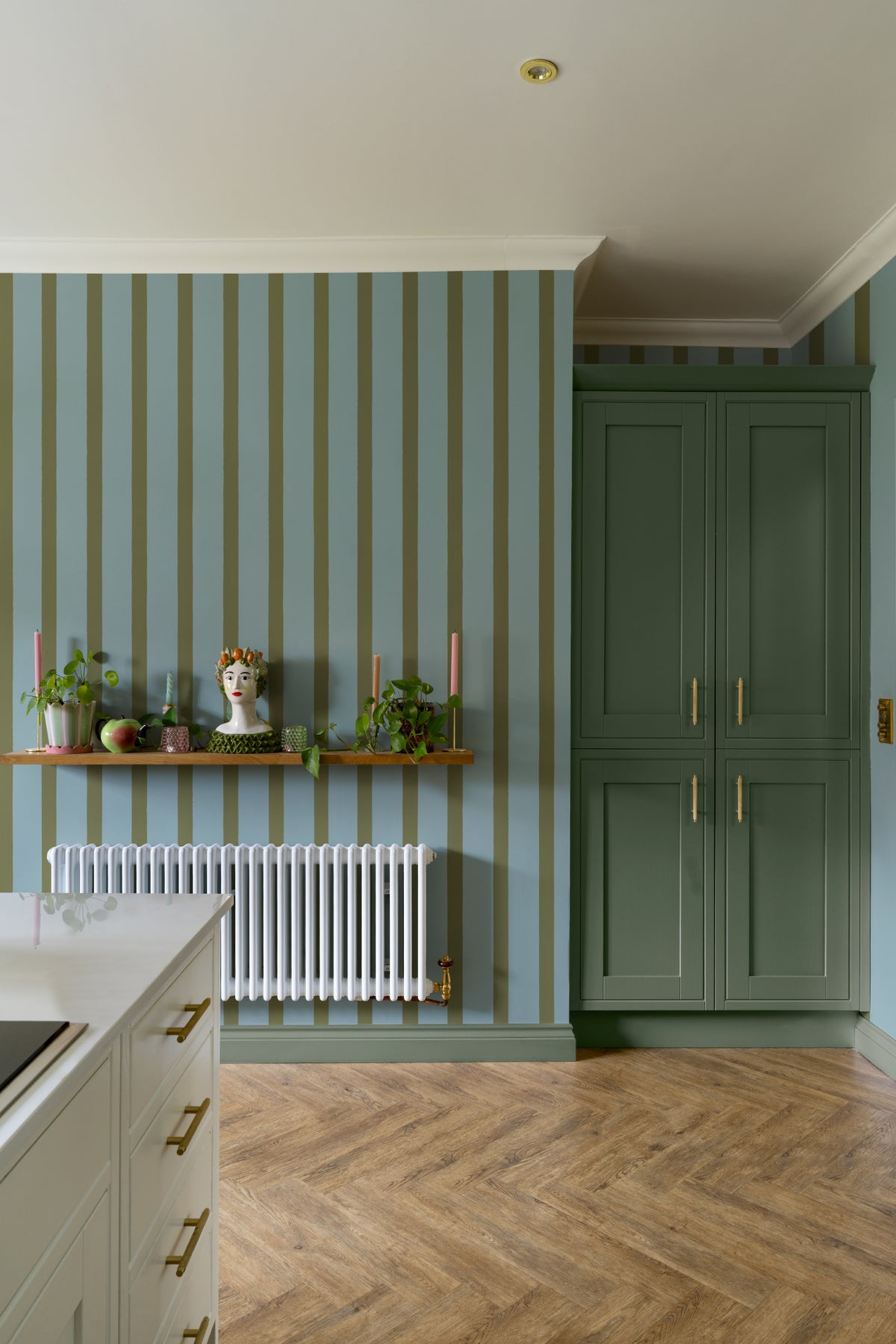 The Deckchair Stripe mural in sage and denim in a hallway