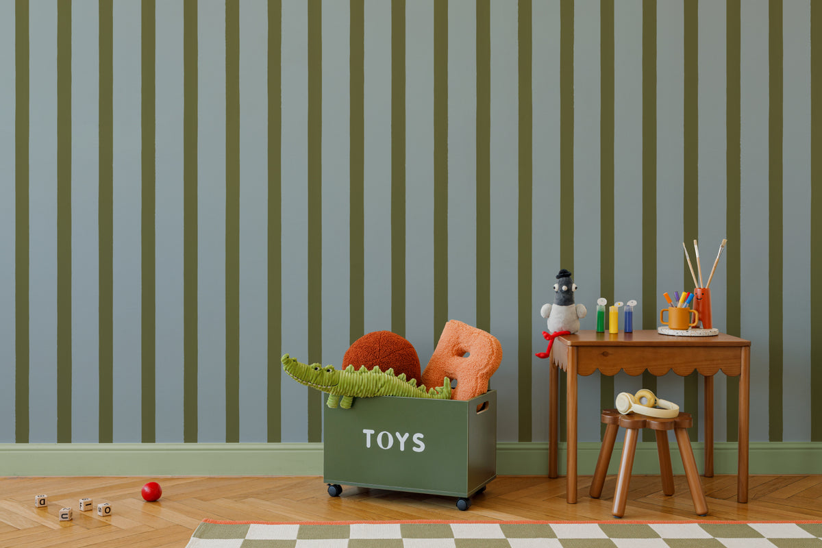The Deckchair Stripe mural in sage and denim on a nursery wall