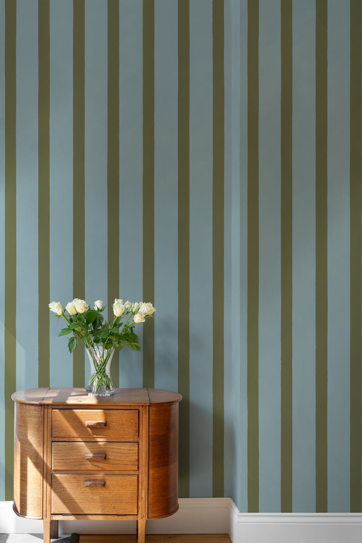 The Deckchair Stripe mural in sage and denim in a child's bedroom