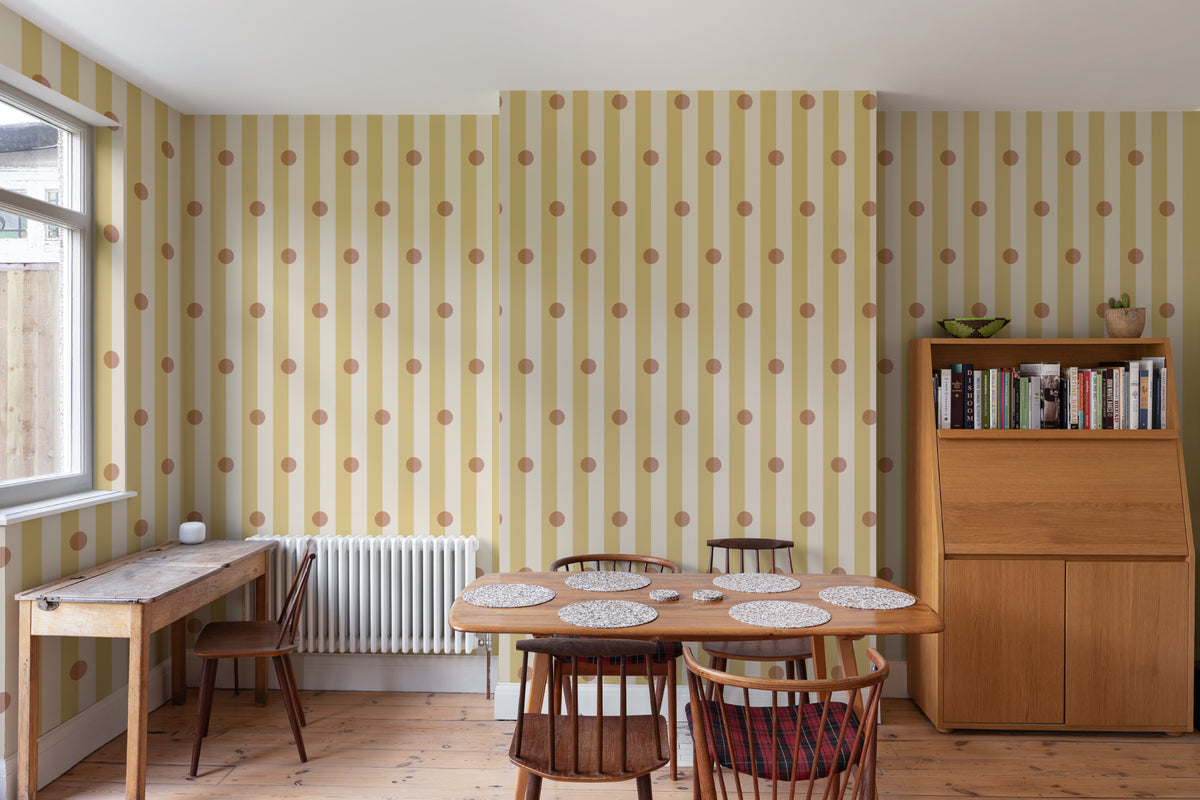The Dotted Awning mural in primrose and blush behind a dining table