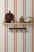 The Draughtsman Stripe wallpaper in burnt orange in a hallway