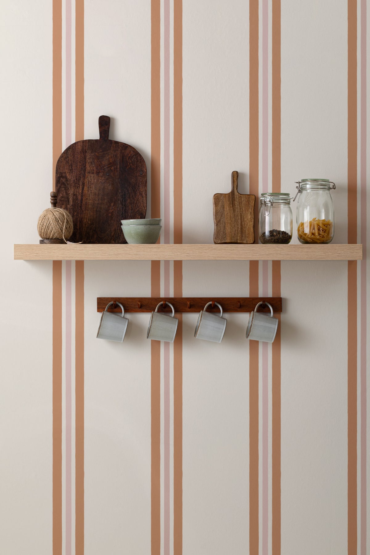 The Draughtsman Stripe wallpaper in burnt orange in a hallway