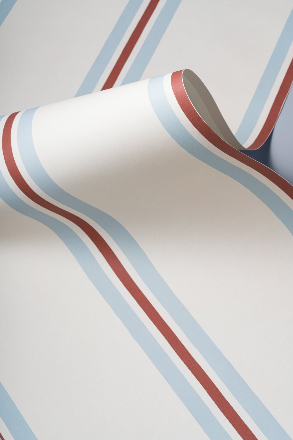 Angled detail of The Draughtsman Stripe wallpaper in sky blue