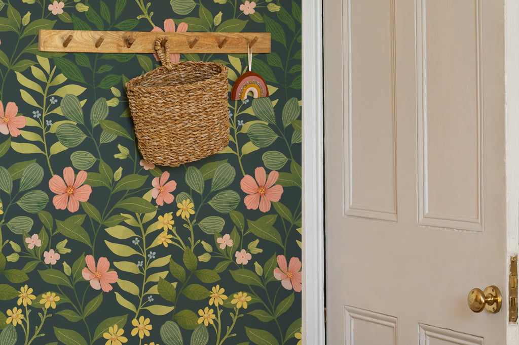 The Dusk Rosarium wallpaper in forest green and blush in a hallway