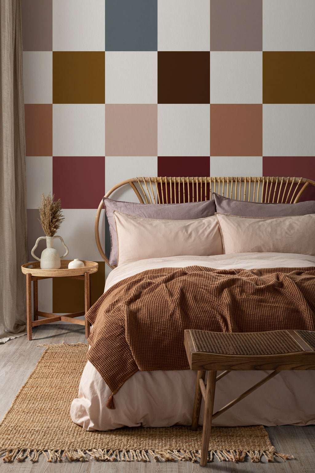 The Earthen Patchwork mural in clay and chocolate behind the bed in a bedroom